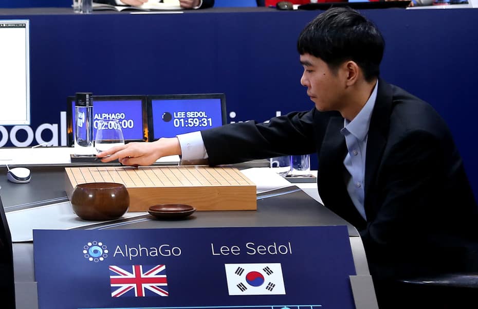 South Korean professional Go player Lee Sedol puts his first stone against Google’s artificial intelligence program, AlphaGo.